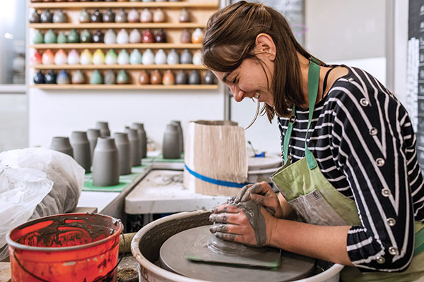 4 Alexandra Corrin, Clay Studio assistant, throwing on the wheel.
