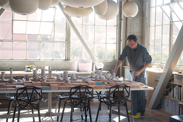 3 Tung Chiang looking over pieces in the studio.