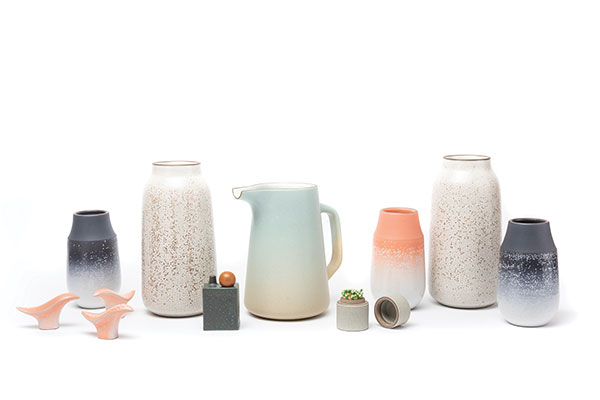 12 Left to right: small birds in grapefruit, Neck Vase in indigo, tall vase in opaque white and matte brown, box and stopper vase, pitcher with handle in aqua and barley, matchstick holder in fog and shell, Neck Vase in grapefruit, tall vase in opaque white and matte brown, Neck Vase in indigo. Tallest piece is 10¾ in. (27 cm) in height.