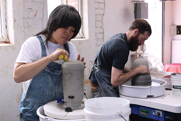10 Rie Dion, Clay Studio assistant, and Jay Dion, Clay Studio manager, trimming Clay Studio vases in the LA Clay Studio.