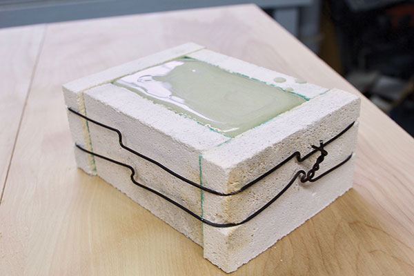 6 Once filled, the mold is allowed to sit until the glaze dries.
