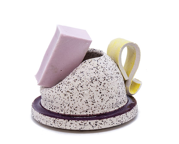 Cup with pink glaze chunk and yellow handle, 3½ in. (9 cm) in height, wheel-thrown porcelain, fired to cone 9 in oxidation, cast and sculpted glaze, fired to cone 02 and cone 1 in oxidation, 2018.