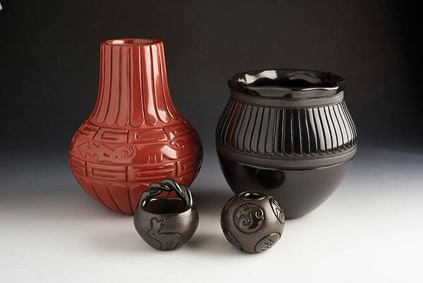 5 Linda Tafoya Sanchez (Santa Clara), red-slipped, tall-neck jar with feathers and Avanyu (back left), black feather jar (back right), black rabbit basket (front left), and mini story bowl (front right), to 11 in. (28 cm) in height, clays.