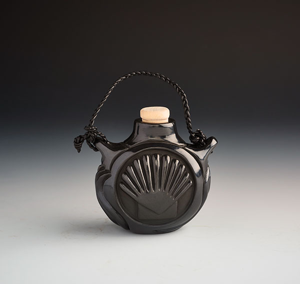 7 Nancy Youngblood’s double-sided shell mini canteen, 4 in. (10 cm) in width, clay and braided leather handle.