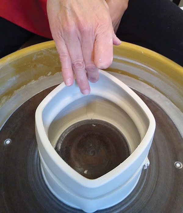 3 Shape the box by pulling outward from the interior, skipping over the flange area.
