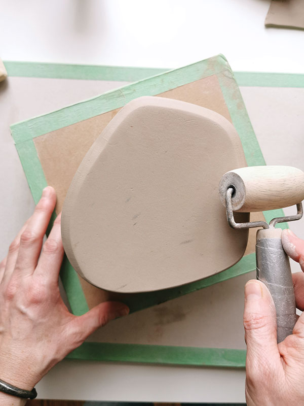 4 Compress and bevel the edge of the attached bottom slab with a pony roller. This strengthens and refines the seam.