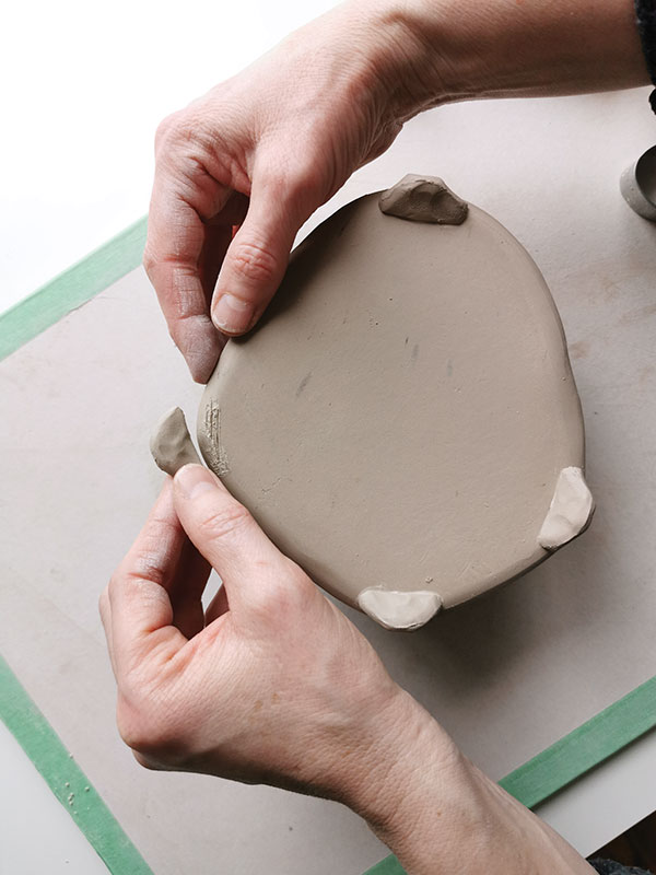 5 Attach feet to the bottom. Allow the feet to set up before flipping the teapot over to ensure they can support the weight.