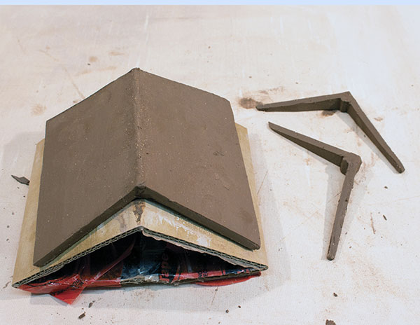6 Use cardboard to support the roof while joining, drying, and adding texture. 