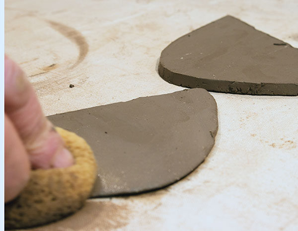 7 Smooth, compress, and pinch around the spout slabs to create a sharp edge.