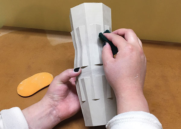 8 Once the piece is nearly dry, use a scouring pad to smooth out any bumps and ridges.