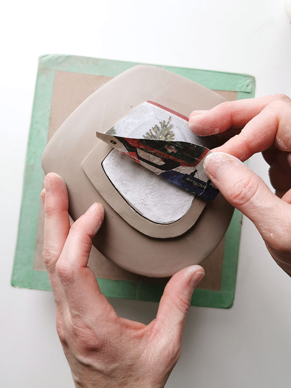 10 Attach the lid assembly to the teapot top with the newsprint attached to prevent the lid assembly from distorting.