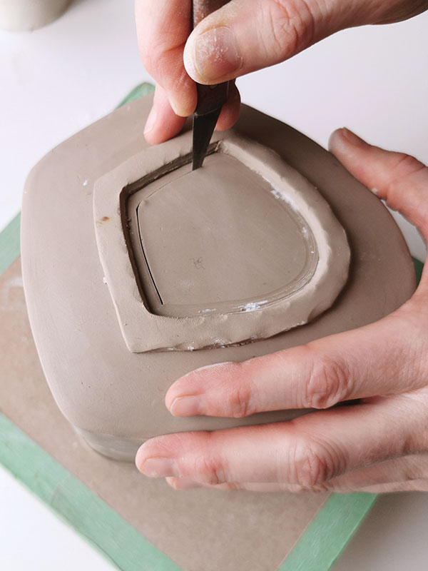 11 Remove the lid and set aside. Leaving a narrow flange, cut away the interior opening. Replace lid and set aside.