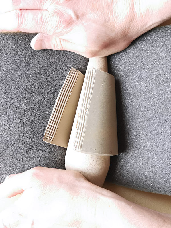 13 Shape the handle using a tapered wooden spout maker. Add slip to the scored ends, join, then compress the seam.