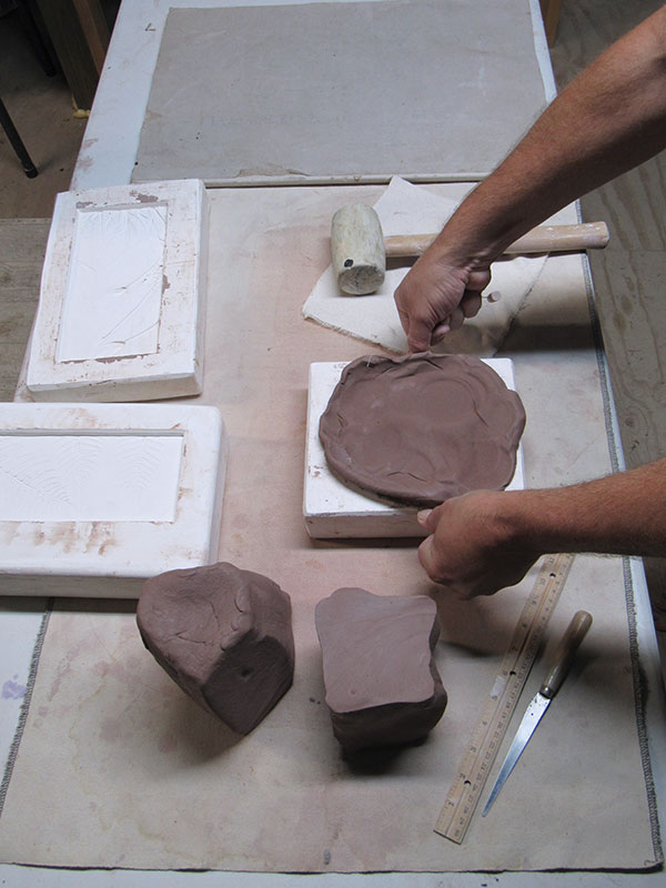 15 Remove the excess clay by dragging a wire against the surface of the mold.