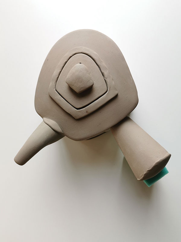 18 Add a knob to finish the lid. Support the handle with a dry sponge while the teapot slowly dries. 