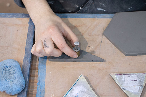 3 Cut a 1/2-inch diameter hole out of the trapezoidal slab. This is centered and where your air plant will be positioned in the planter. 