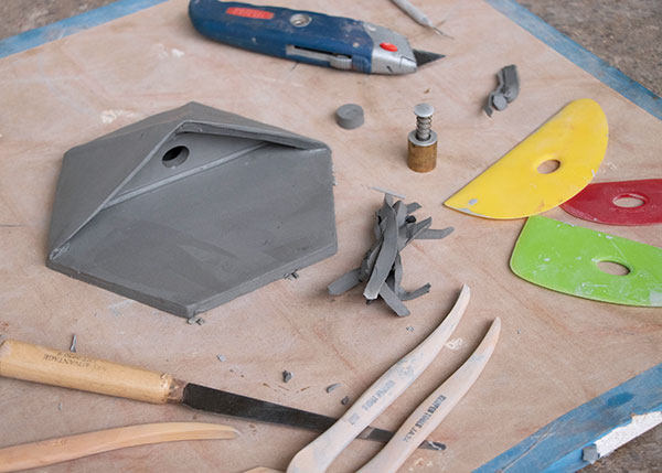 9 Handbuilt planter shelf showing the ideal, centered placement of the hole. Note the beveled top edge of the triangular walls. 