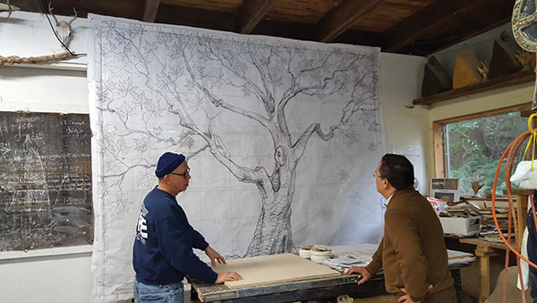 3 Richard Rowland meeting with Randy McClelland in early 2017 to discuss the work to be done on the Planetree mural for CMH. The scale drawing for the mural hangs in the background. Photo: Chris Laman.