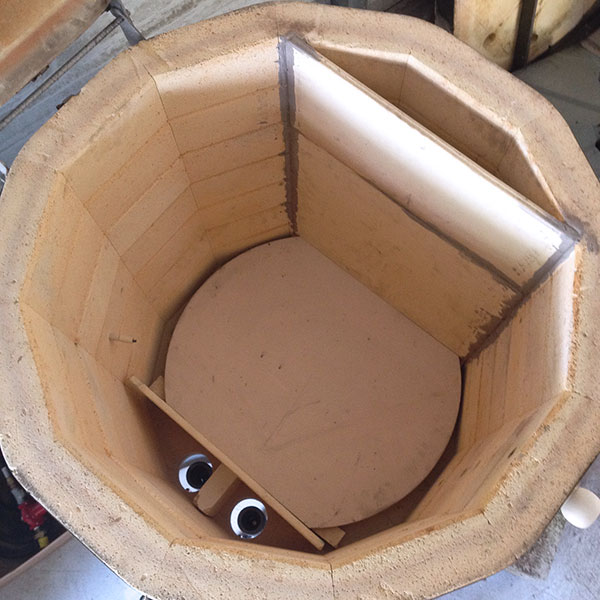 Interior of the 8×32-inch kiln showing the burner and flue walls.