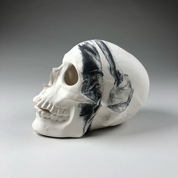 2 Juan DeJesus Barroso’s No More Deaths from Dehydration, 7 in. (18 cm) in length, low-fire clay, stippled underglaze illustration, fired to cone 04 in oxidation, 2019. 