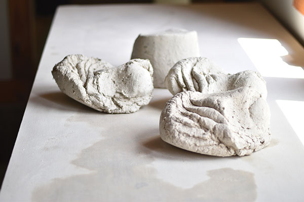 3 Wedge the fiber clay to a uniform consistency to prepare it for wheel throwing. 