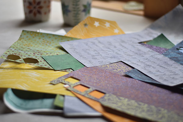 4 Cut shapes from colorful, recycled printed paper to create quilt-like patterns that can be applied to the urn’s surface. 