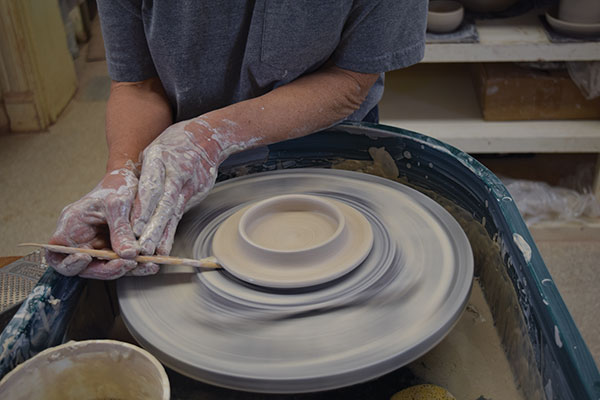 6 Use a wood tool to slightly lift the edge of the lid and trim away any excess.