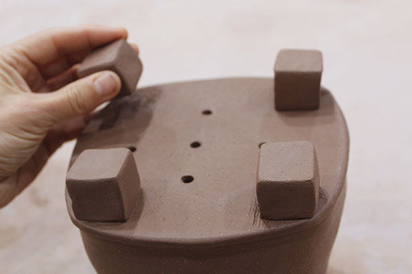 6 Add four square feet to the slab bottom, one on each corner.