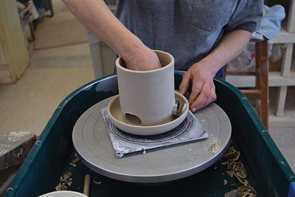 8 Cut 3 equally spaced holes at the base of the cylinder using a 1 1/2-inch round cookie cutter that has been flattened into an oval.