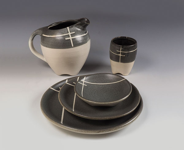 2 Dinnerware set with G2934 base +5% Zircopax sprayed over G2934 base + 6% red iron oxide +2% Mason Stain 6600. Pattern created by taping areas before spraying the second glaze.