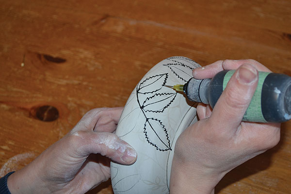 12 Slip trail black underglaze over the drawn lines to highlight the rowan leaves.