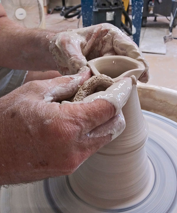 3 Gradually collar the cylinder to create an opening the diameter of your finger.