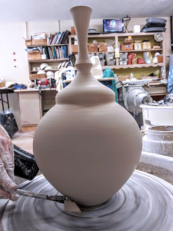 15 Trim the excess clay away at the base and sides, then burnish surface.