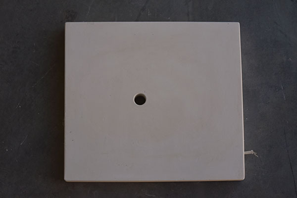 16 Plaster base with drain hole for ball-valve assembly.