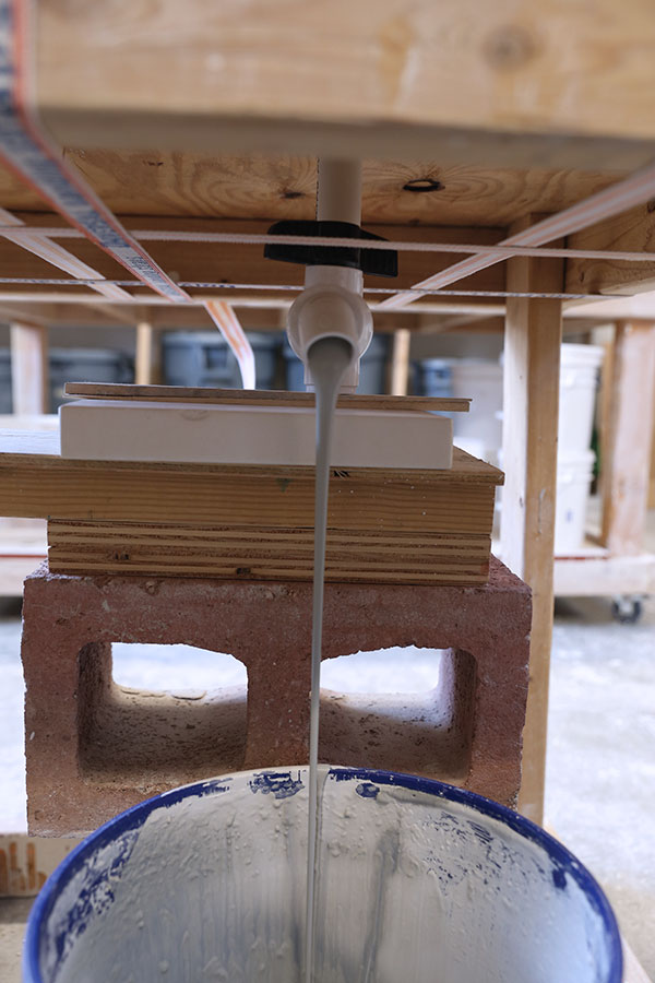 17 The ball-valve assembly controlling the rate of draining slip from the mold.