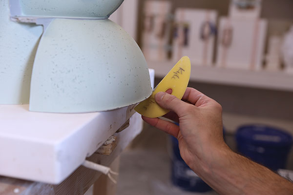 20 Smooth the bottom and bevel the bottom edge with a soft rib to prevent chipping and scratching.