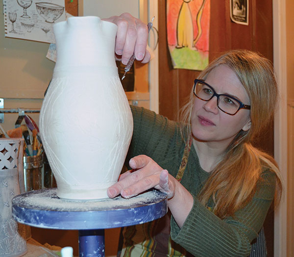 2 Dawn Candy inscribing leaves onto a pitcher, 2020. Photo: Dean Scott.
