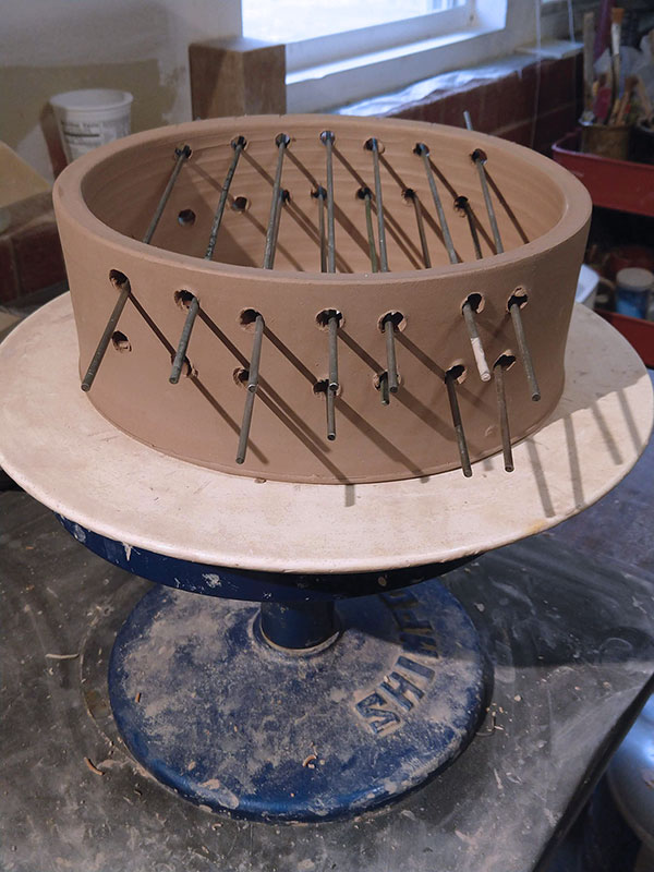 3 The rods should slide through the holes on each side. 