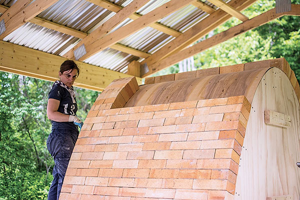 Crosby building a kiln. Photo: Kathleen Fisher.