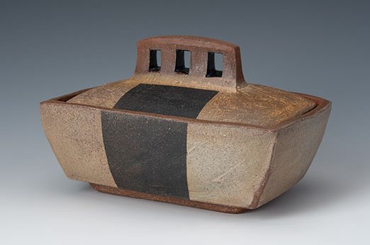Box, 7 in. (18 cm) in length, handbuilt cone-3 earthenware, terra sigillata, black stain, wood/soda fired. Photo: Ann Cady.