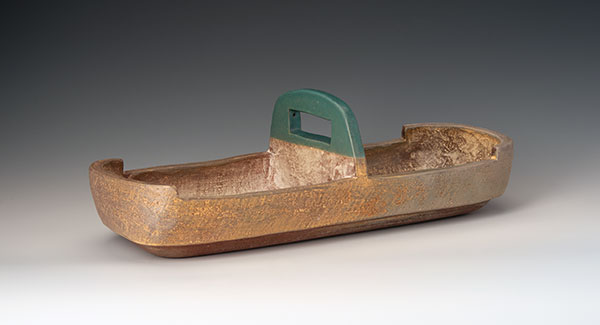 Divided server, 16 in. (41 cm) in length, cone-3 earthenware, terra sigillata, turquoise glaze, wood/soda fired. Photo: Ann Cady.
