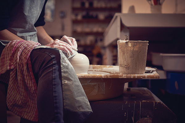 2 Jo Davies smoothing and compressing the form of the Speak Vase to reinforce the structure of the closed form and prevent cracking of the porcelain.
