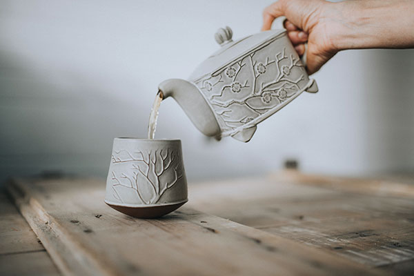  4 Blossom Rectangle Teapot and Winter Tree Sipper, to 8 in. (20 cm) in width, red stoneware. Photo: Eva Grace Photography.
