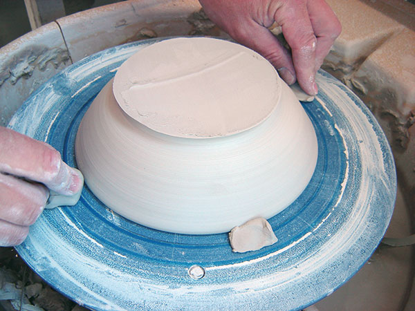 1 Use wads to secure the leather-hard bowl to the bat before trimming into a dome.
