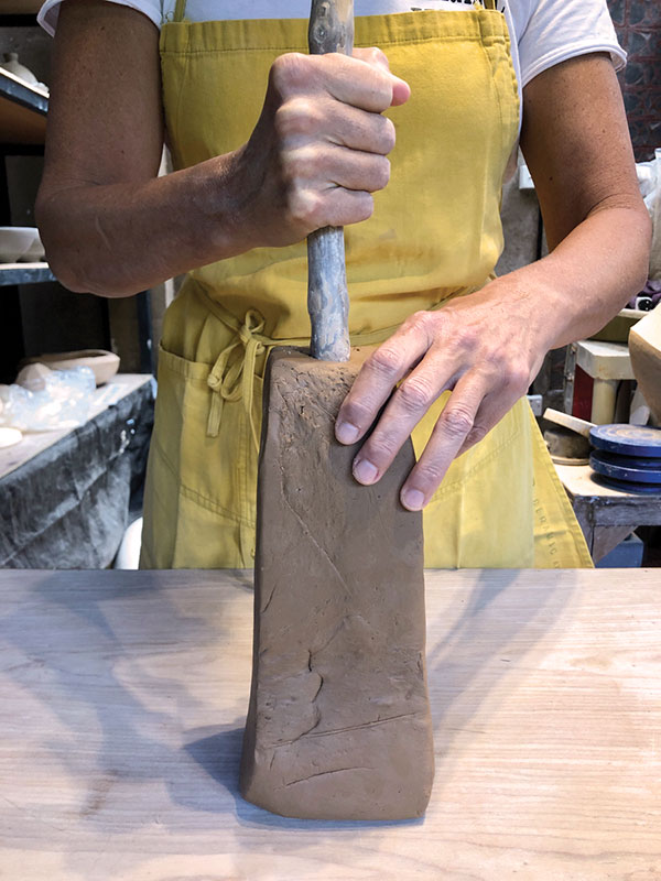 2 Drive a dowel rod or stick into a sold block of clay.