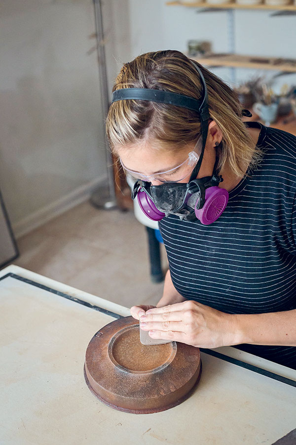 2 Use a diamond sanding pad to smooth feet with rough edges. Always wear a respirator when sanding fired clay.