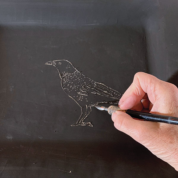 3 Remove the tracing paper, then follow the indented line with an etching tool.