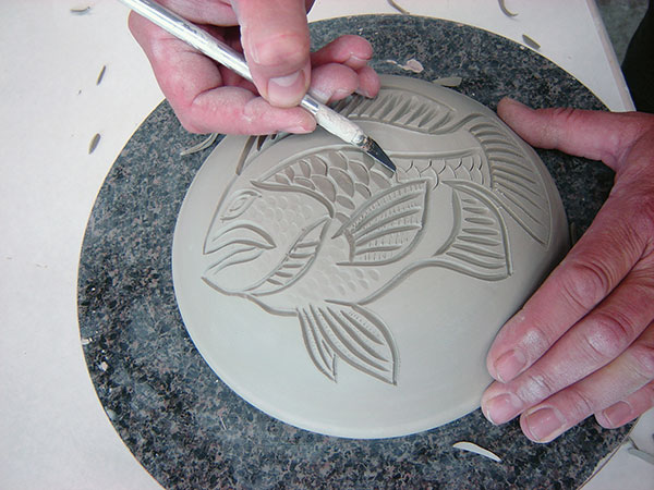 6 Carve scales by making two cuts from opposing angles.
