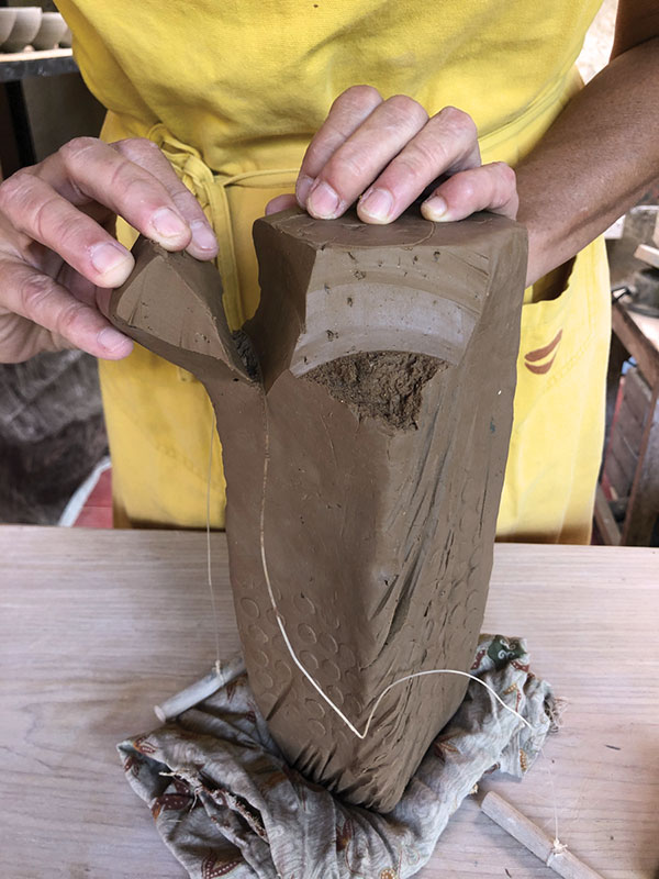 7 Remove small sections of the form to shape the block into a vessel.