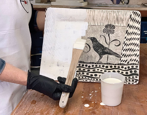 10 After bisque firing your carved platter, brush on an even coat of clear glaze.